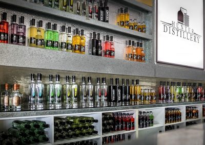 Behind the counter at Hunter Gin Distillery - view of many bottles of gin