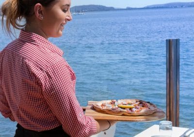Commercial food photography of meal being served with water views