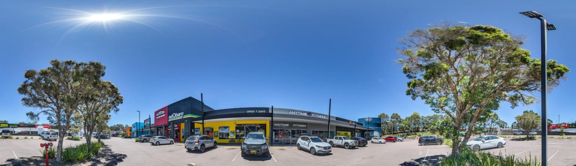 Storefronts at Lake Haven shopping plaza, captured during an Anytime Fitness 360 virtual tour shoot by Work Pics 360